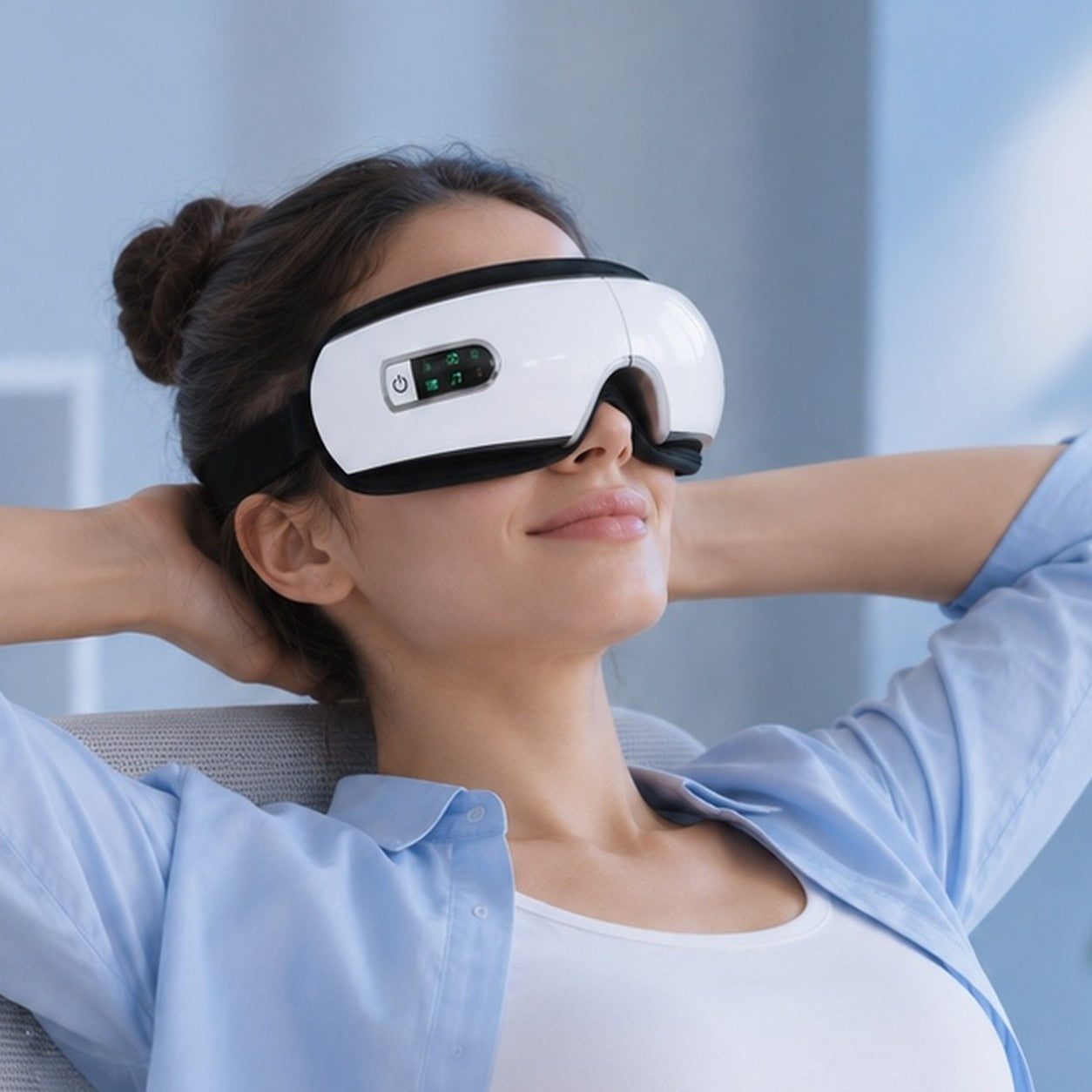 A woman leaning back with her hands behind her head, wearing the massager